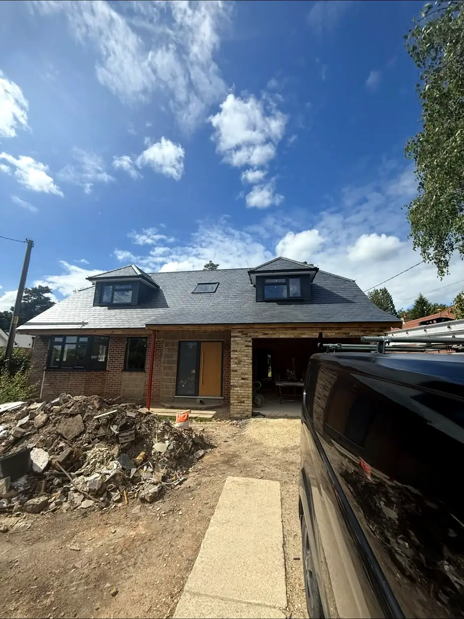 New slate roof with dormers and rooflight on a rebuilt house